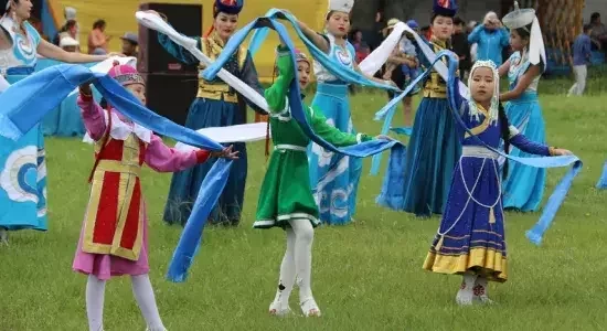 Children performing a traditional Mongolian folk dance in colorful costumes
