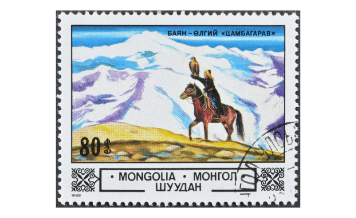 Vintage Mongolia postage stamp featuring a Kazakh eagle hunter on horseback in the Altai Mountains