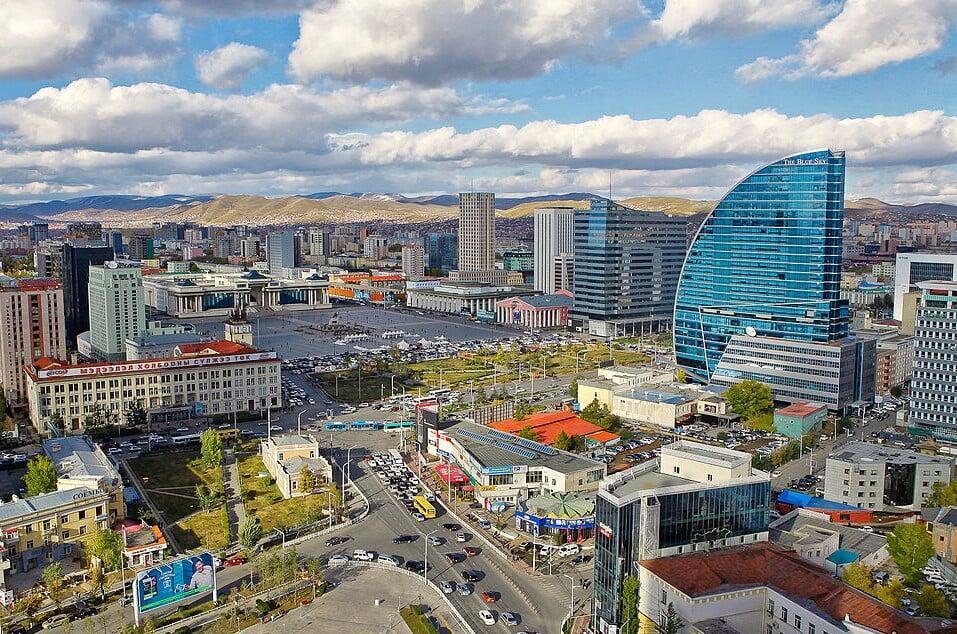 Horseback riders exploring lush spring landscapes during Mongolia tours