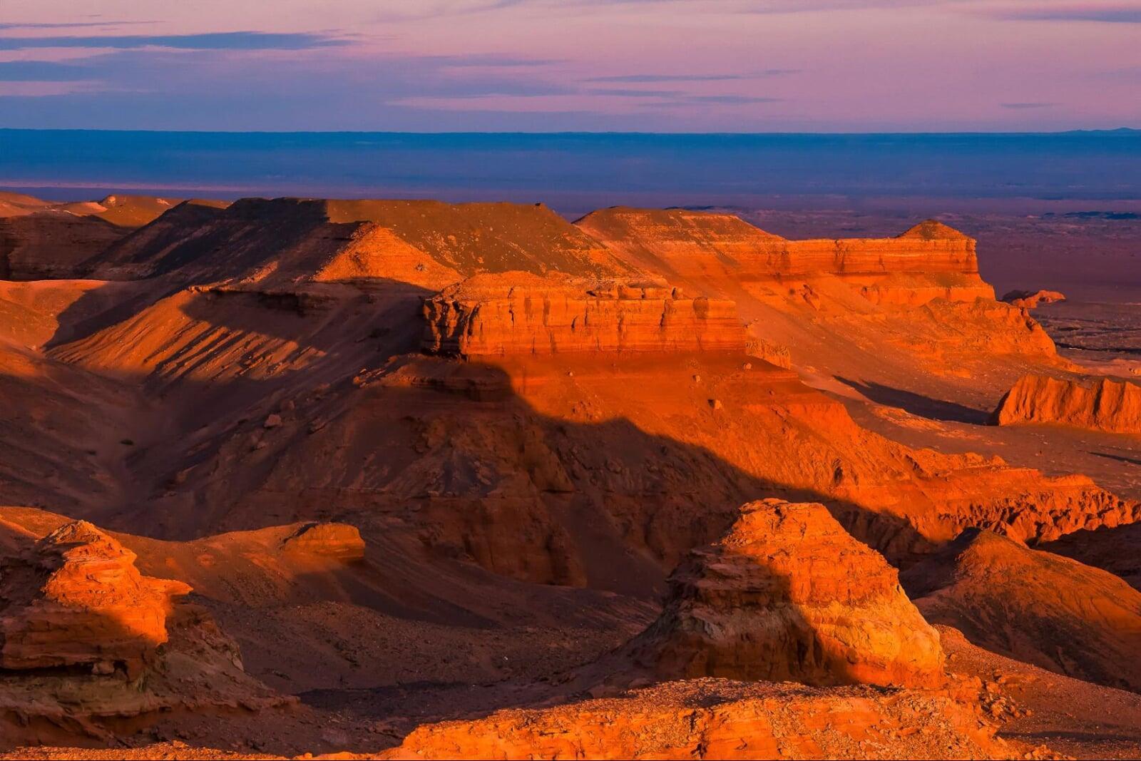 Flaming Cliffs Bayanzag in Mongolian Gobi Desert red sandstone cliffs things to do in Mongolia