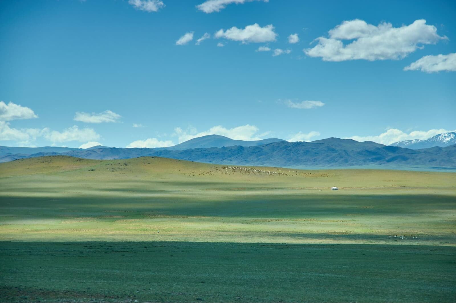 Mongolia open grassland with mountains scenic terrain for off-road cycling tours and adventure travel