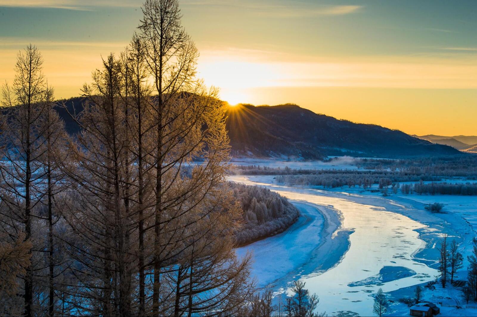Sunrise over a frozen river in Khuvsgul